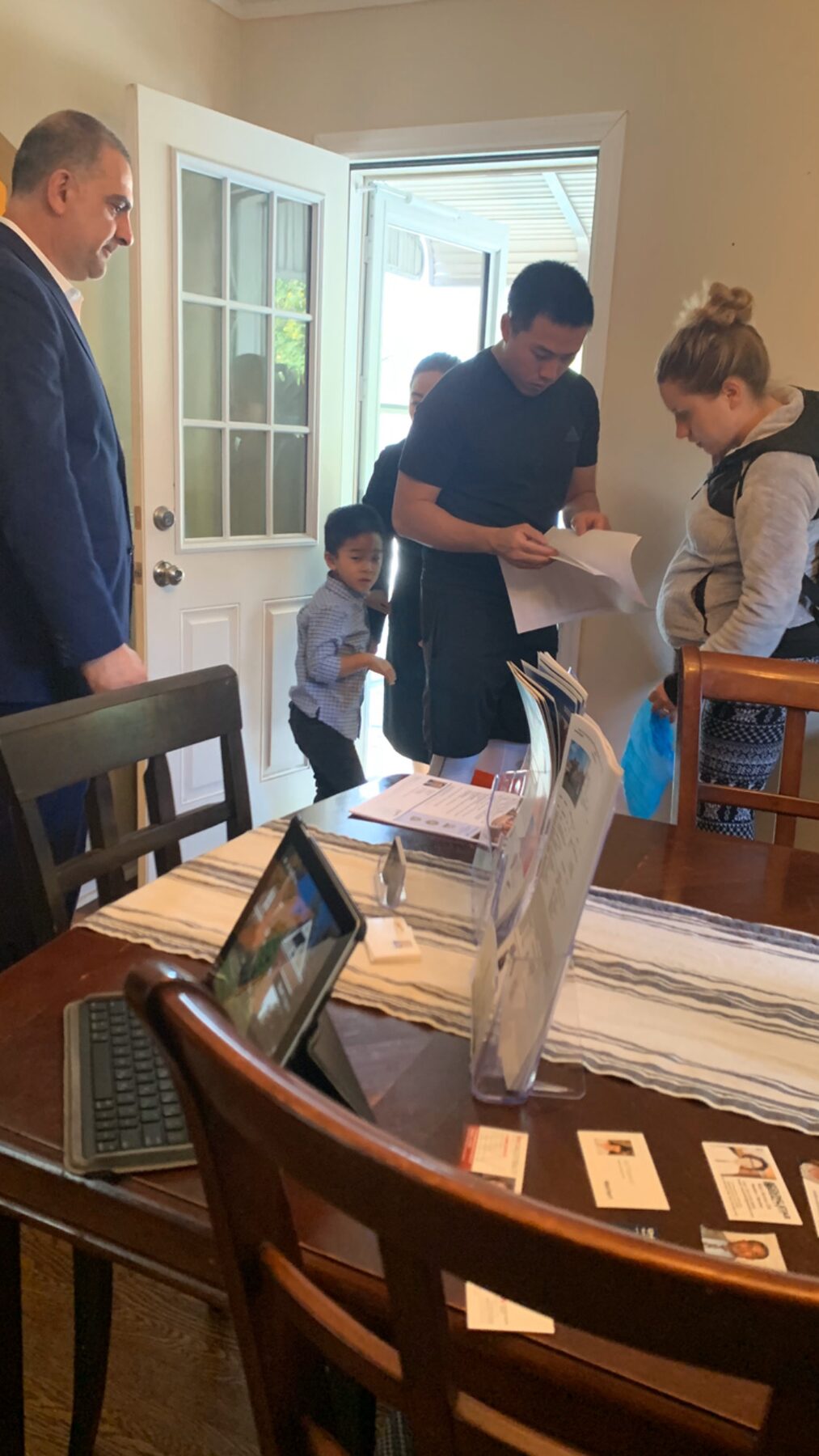 Avo Derbalian hosting an open house with buyers reviewing listing materials in Bergen County NJ