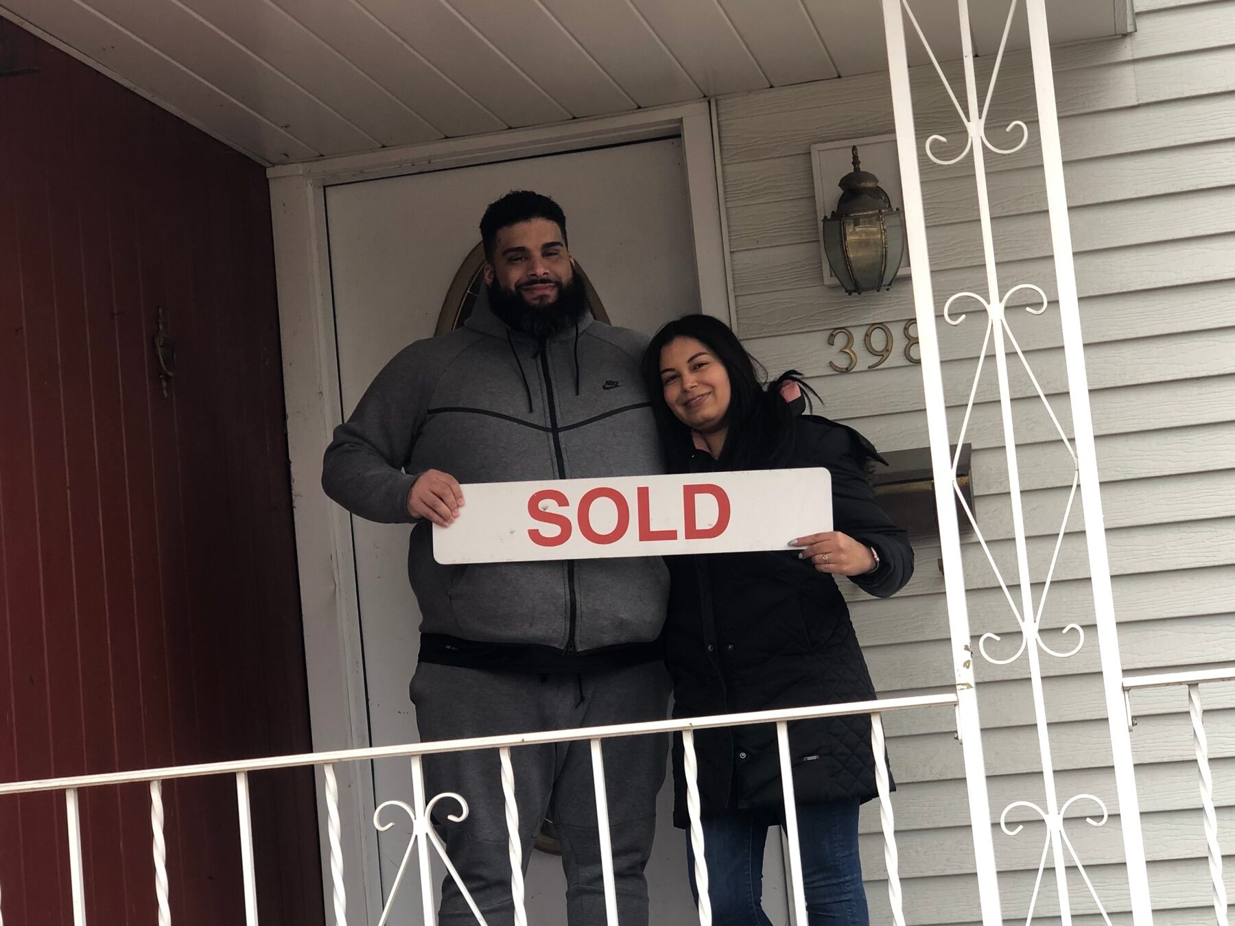 Bergen County sellers with SOLD sign after disciplined pricing strategy